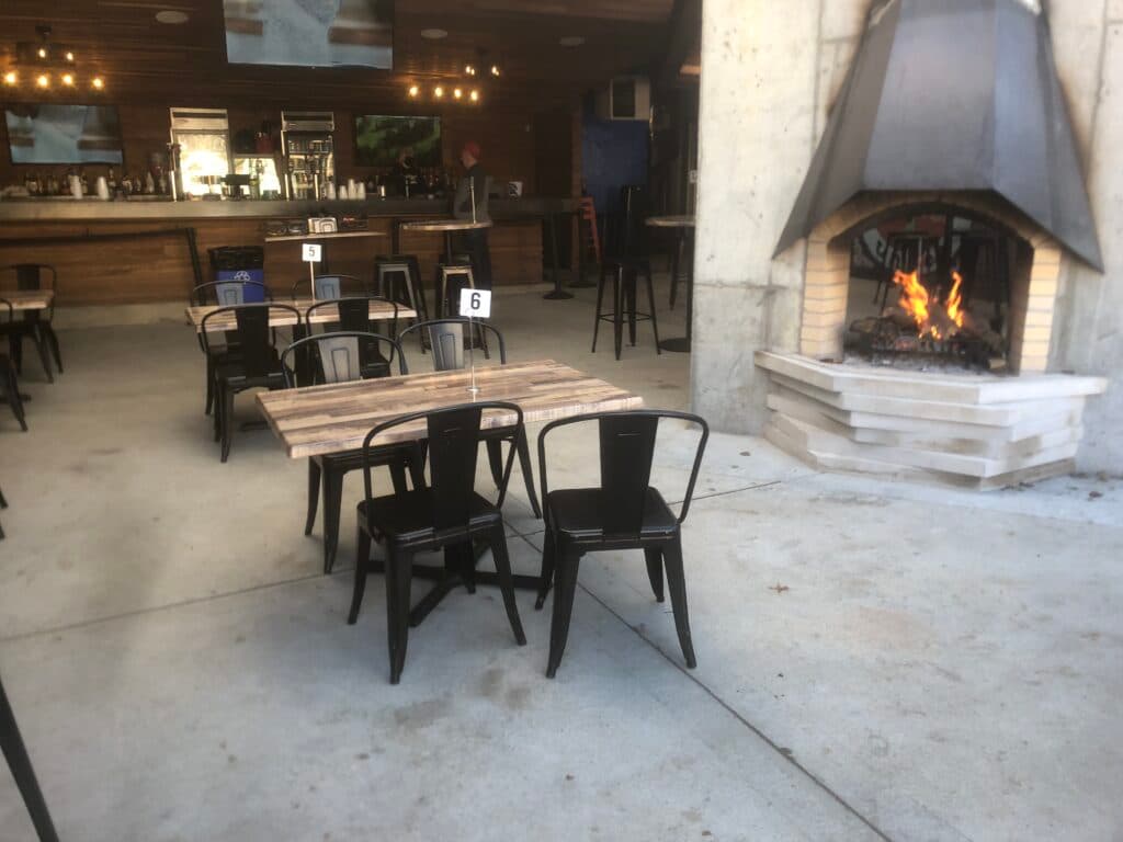 The patio fireplace lit on a quiet afternoon