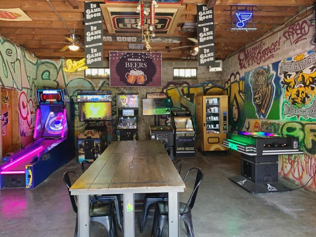 The game room — arcade cabinets, graffiti walls, and the party table