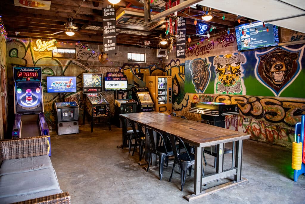 Wide view: pinball and arcade row under the bison mural