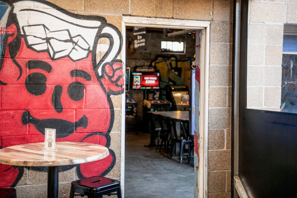 Kool-Aid Man mural guarding the game room door