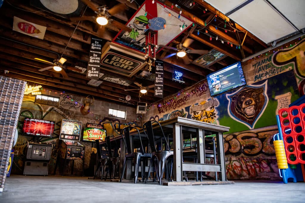 Hanging beer signs over the game room tables