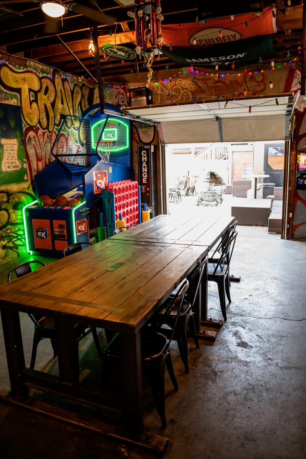 Pop-a-shot and big Connect Four by the roll-up garage door