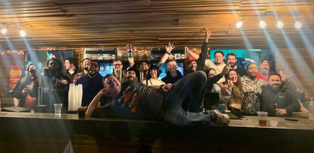 The whole crew celebrating behind the bar
