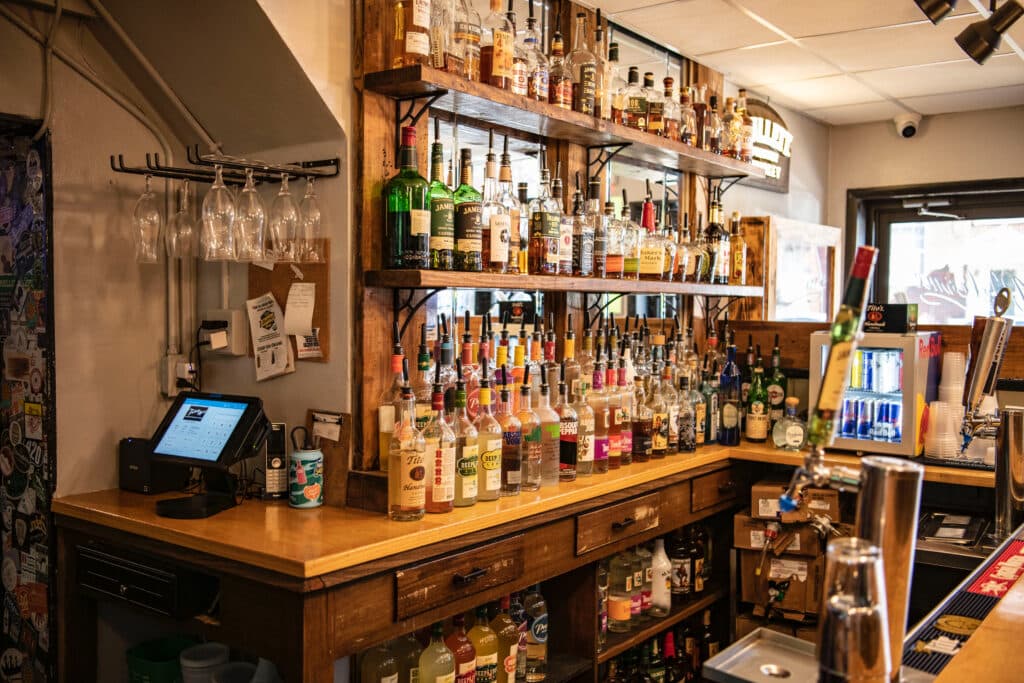 The back bar — shelves stacked with bottles