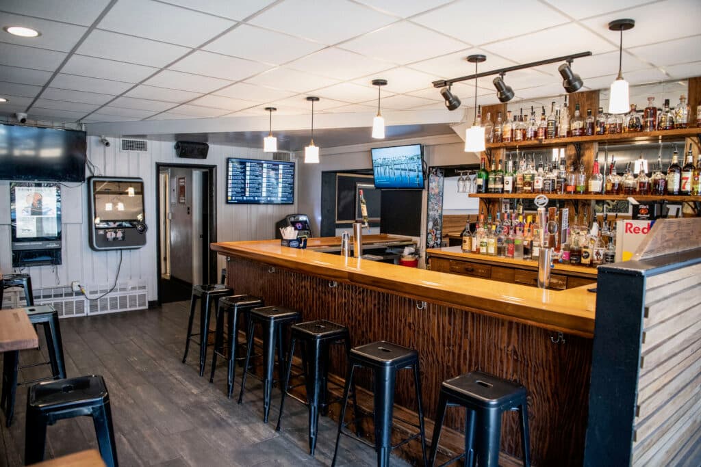 Pendant lights over the empty bar, taps ready