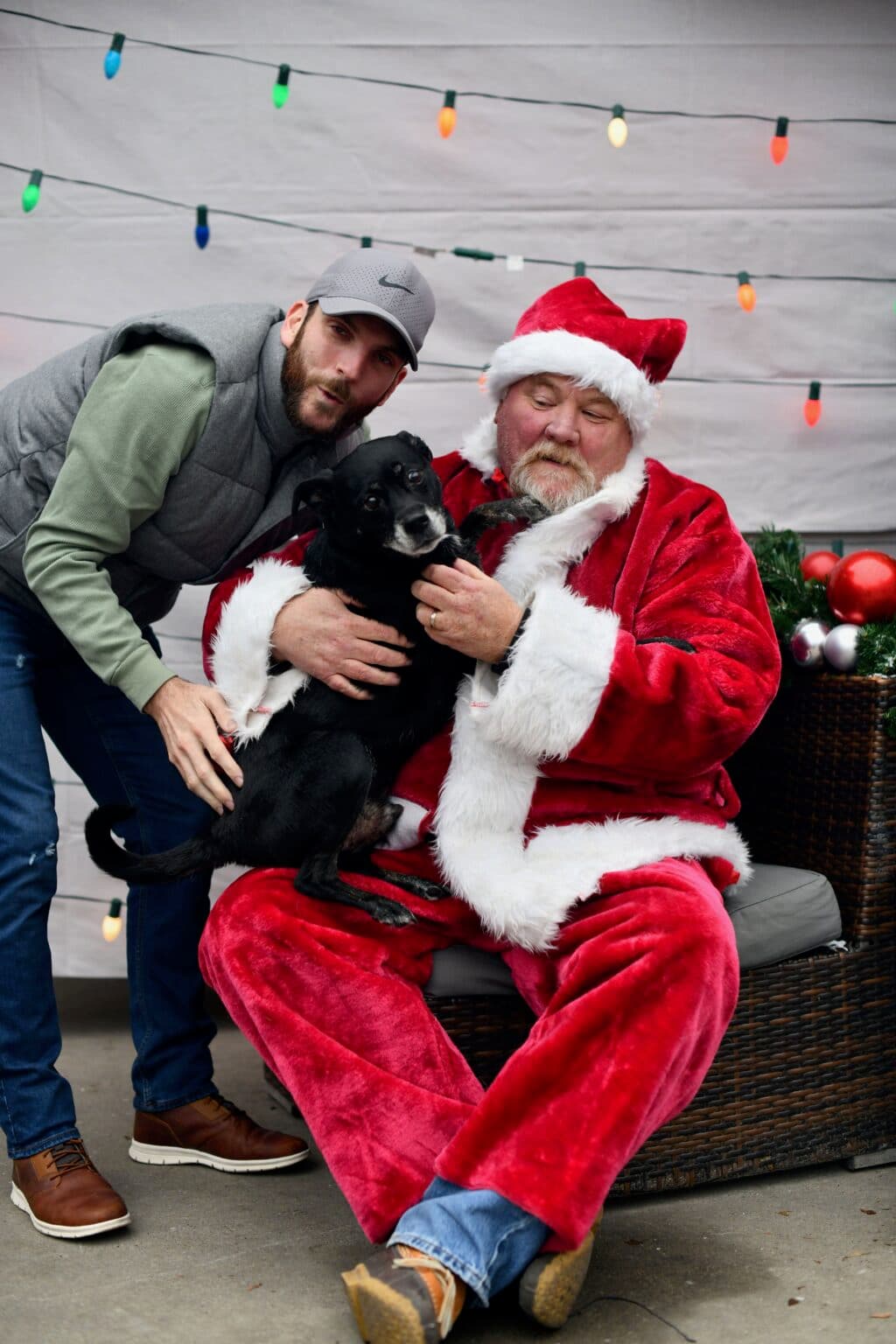 Santa with a black dog and their person