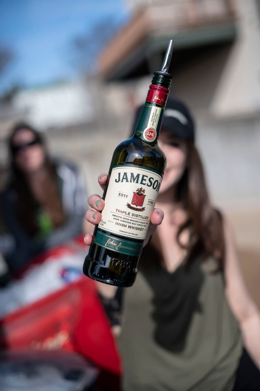 A bottle of Jameson offered straight to the camera