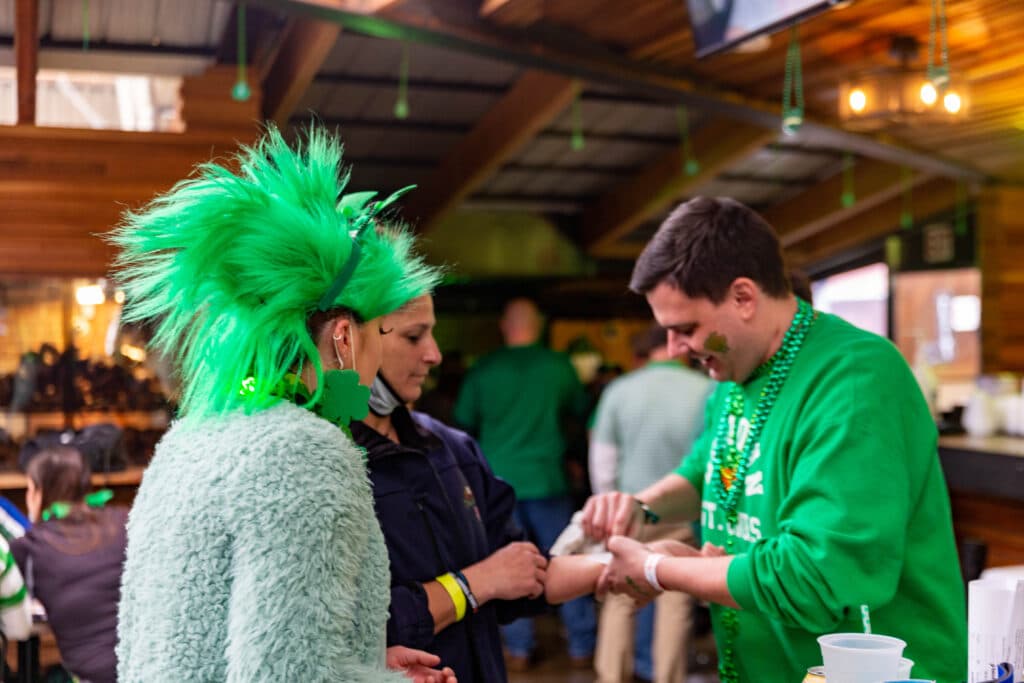 Green mohawk at the wristband table