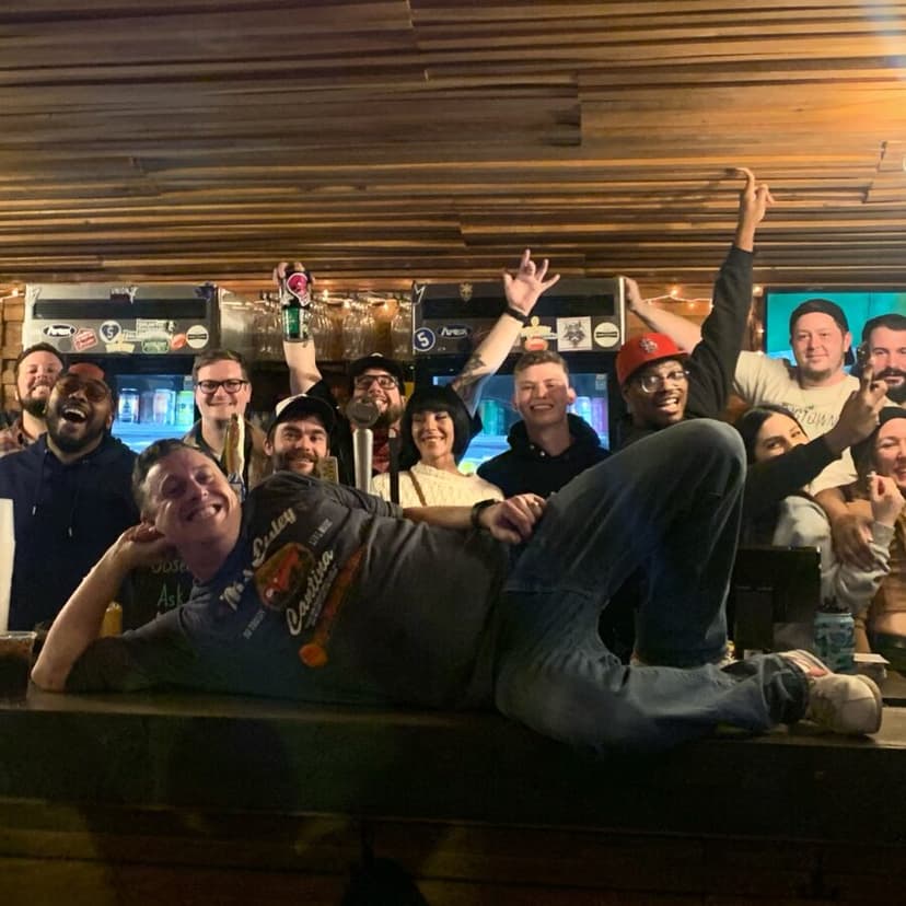 A crowd celebrating behind the bar inside Tamm Ave